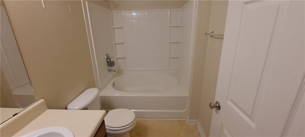 8304 Fairington Ridge Circle Lithonia, GA 30038 - Photo 13 of 14 a bathroom with a toilet and shower