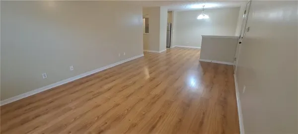 a view of hallway with wooden floor