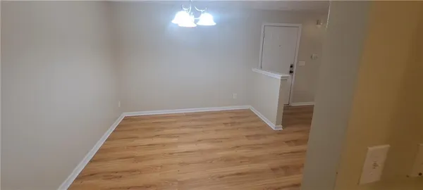 a view of a room with wooden floor and a window