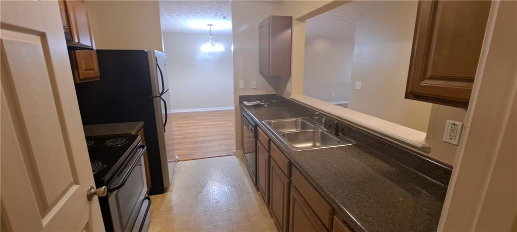 8304 Fairington Ridge Circle Lithonia, GA 30038 - Photo 6 of 14 a view of a refrigerator and a stove in a kitchen