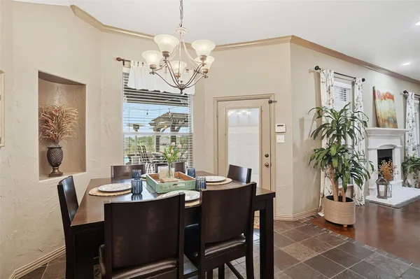 a view of a dining room with furniture a chandelier and wooden floor