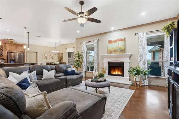 a living room with furniture a large window and a fireplace