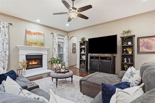 a living room with furniture a fireplace and a flat screen tv