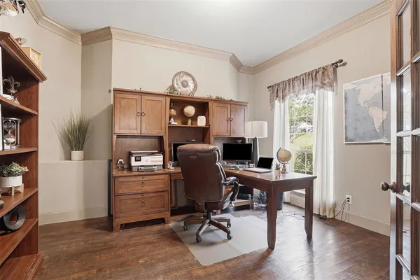 a view of a workspace with furniture and a window