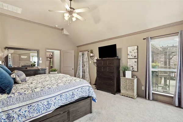 a bedroom with a large bed and a flat screen tv