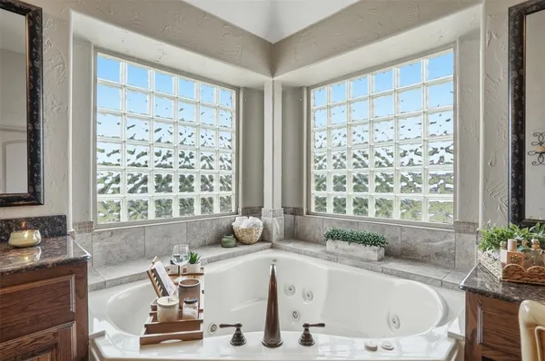 a bath tub sitting in a bathroom next to a window