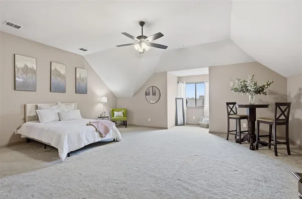 a spacious bedroom with a bed and a table