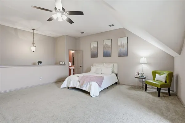 a spacious bedroom with a bed and furniture