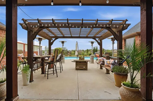 a view of dinning table and chairs in patio