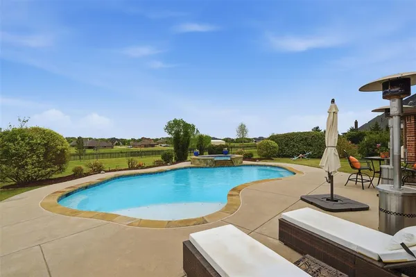 a view of a swimming pool and lake from a balcony