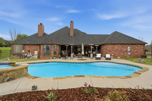 a view of house with swimming pool yard fire pit and outdoor seating