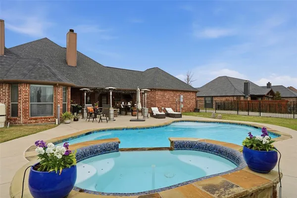 a view of a house with swimming pool and porch