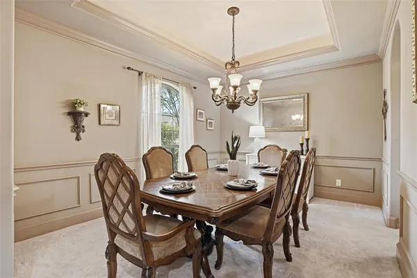 a view of a dining room with furniture and chandelier