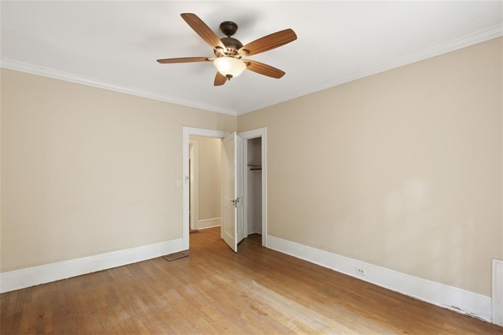 1424 Emory Road Northeast Atlanta, GA 30306 - Photo 24 of 36 an empty room with wooden floor and ceiling fan