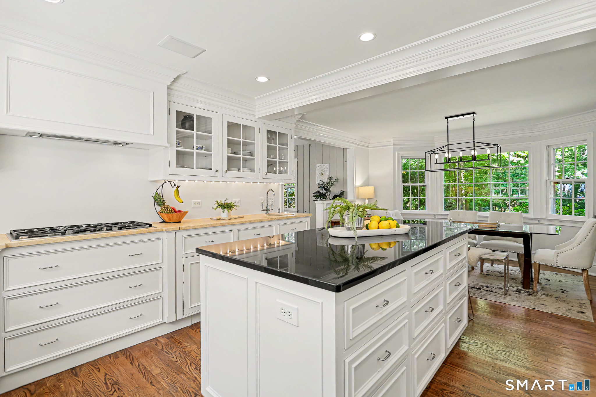 6 Adams Way Weston, CT 06883 - Photo 9 of 40 The gorgeous eat-in-kitchen with granite and quartz counters, beautiful white cabinets, and stainless appliances.