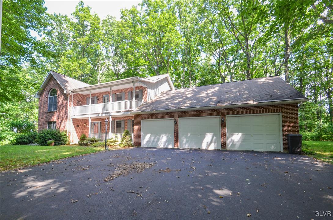 375 Woodline Road Nazareth, PA 18064 - Photo 1 of 22 a front view of a house with a yard and a garage
