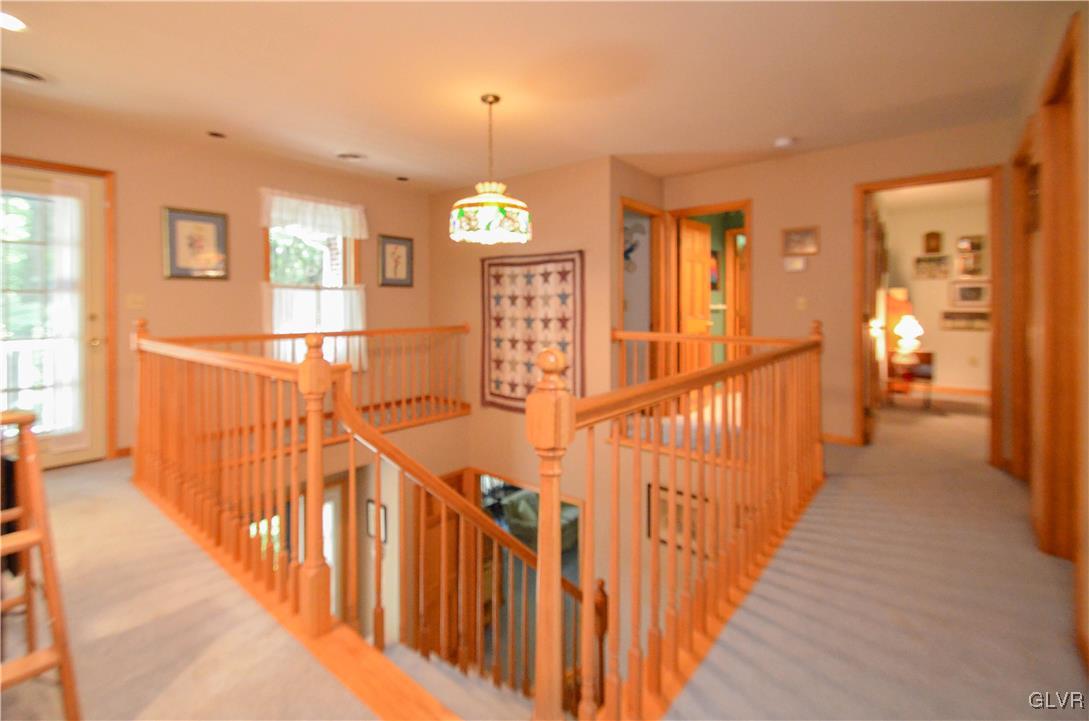 375 Woodline Road Nazareth, PA 18064 - Photo 12 of 22 a view of a hallway with wooden floor and stairs