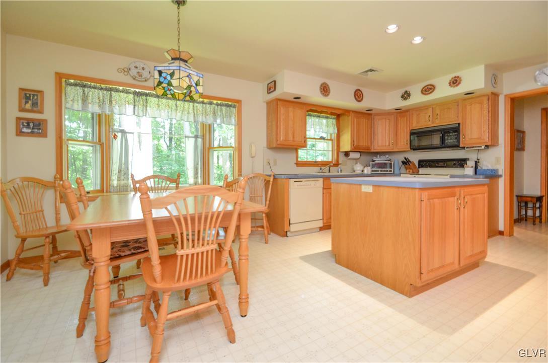375 Woodline Road Nazareth, PA 18064 - Photo 4 of 22 a view of a dining room with furniture a chandelier and large window