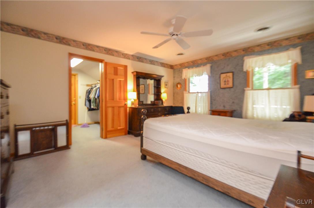 375 Woodline Road Nazareth, PA 18064 - Photo 9 of 22 a spacious bedroom with a large bed and a chandelier