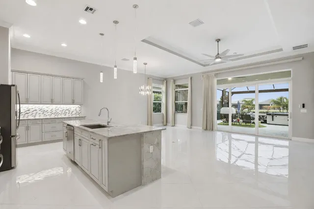 a large white kitchen with a large window