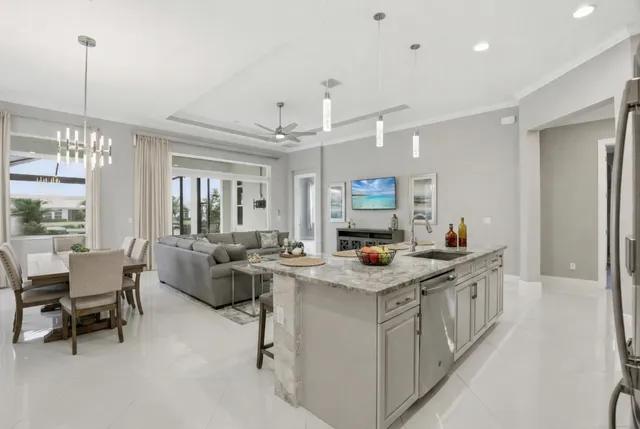 a kitchen that has a lot of cabinets a sink and a wooden floor