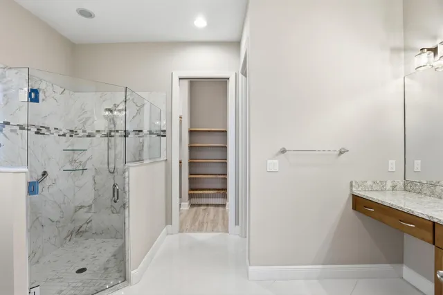 a bathroom with a shower and a sink
