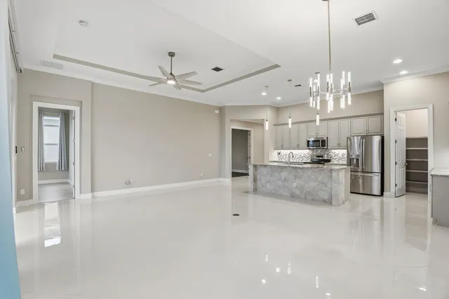 a view of kitchen with refrigerator and window