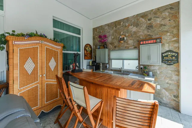 a living room with patio furniture and a floor to ceiling window