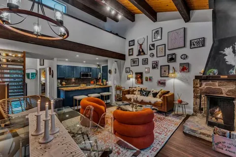a living room with furniture a flat screen tv and a fireplace