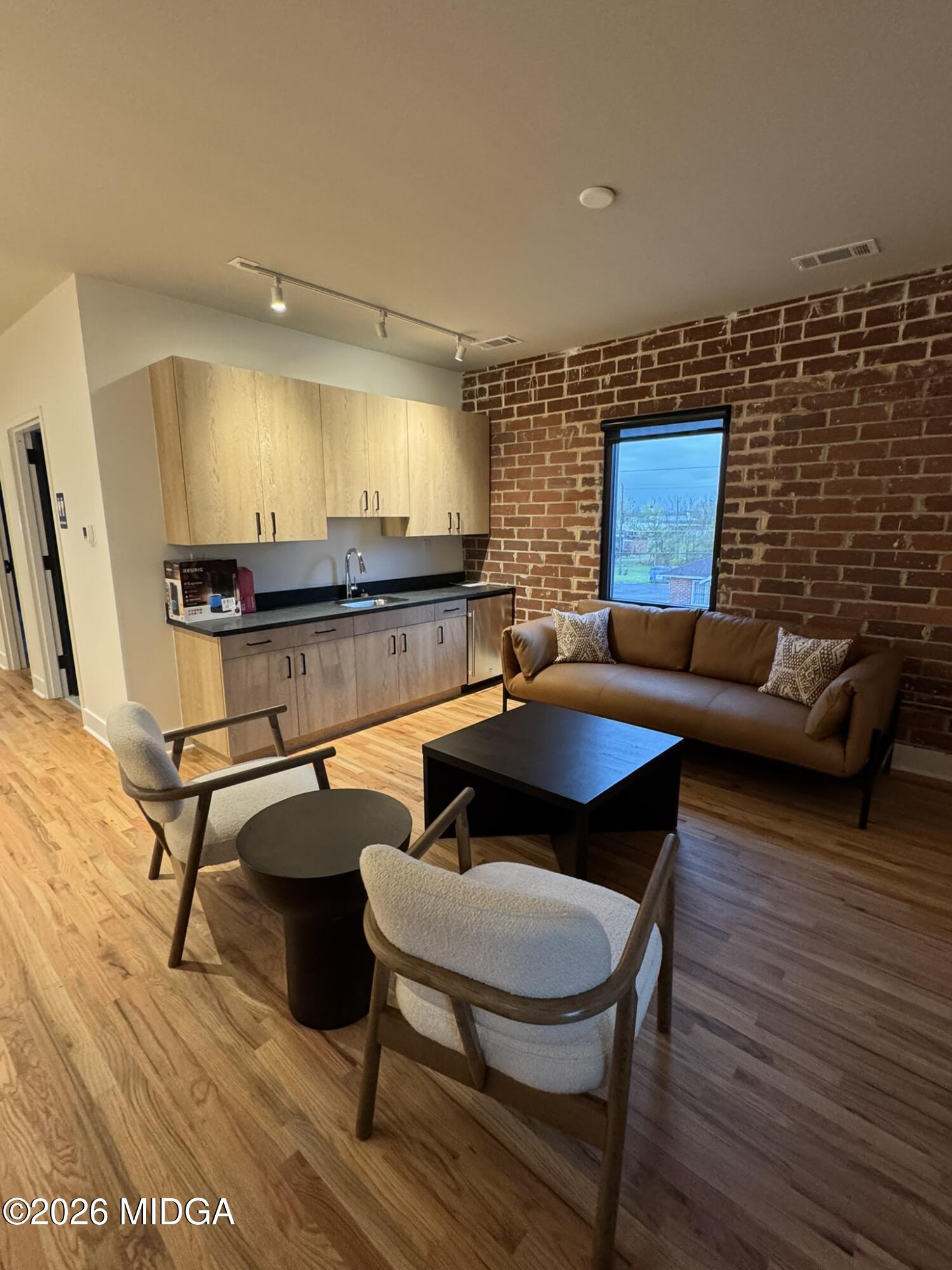 1080 3rd Street Macon, GA 31201 - Photo 17 of 18 a living room with furniture a rug and a wooden floor