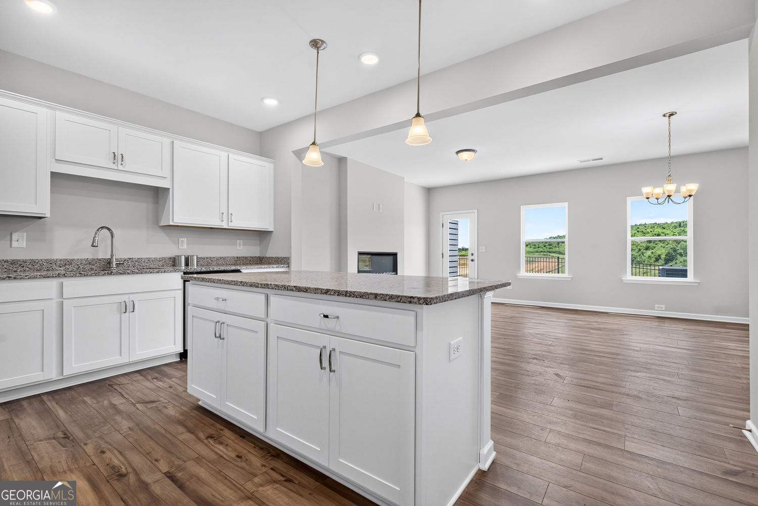 155 Oconee Road, Unit 252 Cartersville, GA 30120 - Photo 16 of 39 a kitchen with kitchen island granite countertop a stove a sink and white cabinets with wooden floor