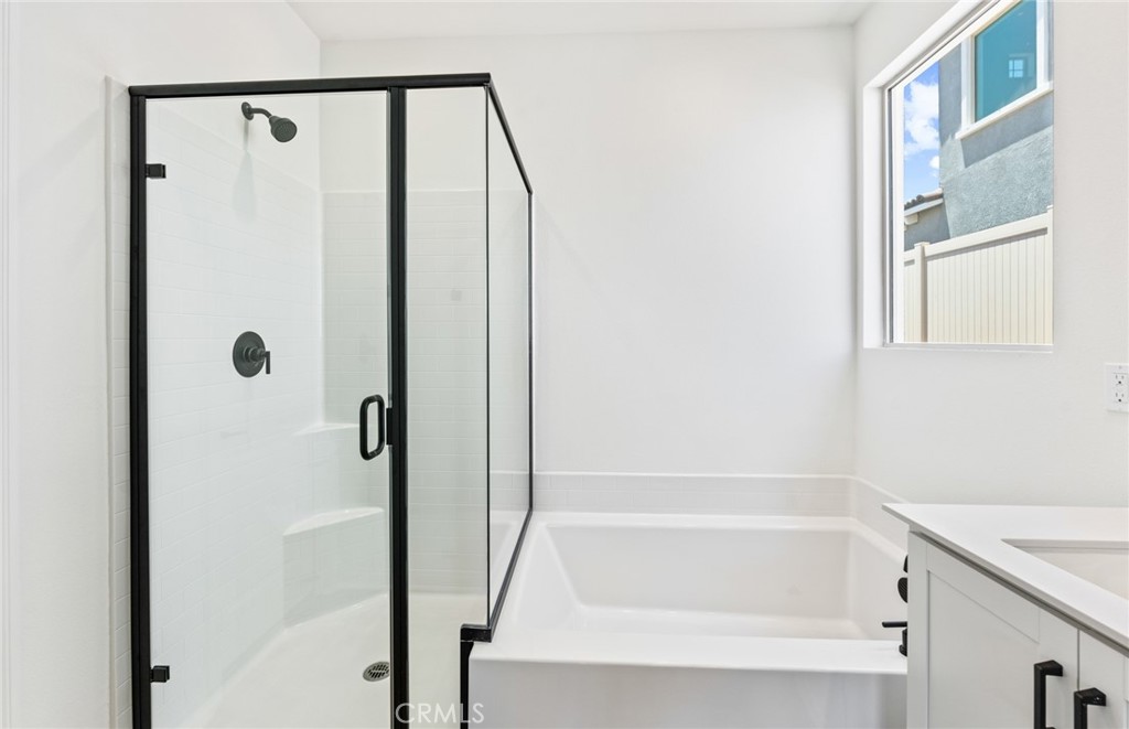 25344 Picket Range Way Menifee, CA 92586 - Photo 18 of 29 a bathroom with a shower and a bath tub