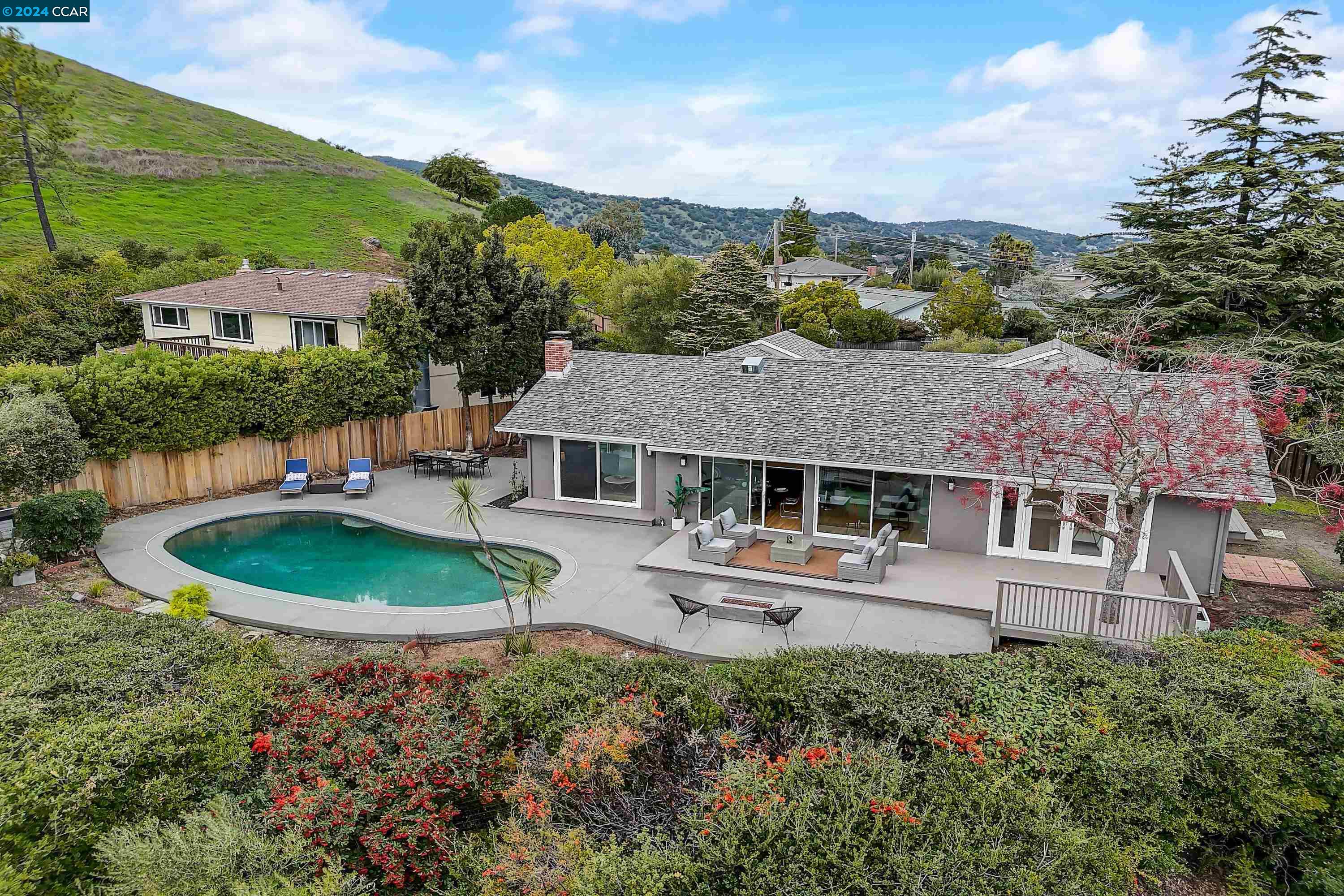 an aerial view of a house with a garden and trees