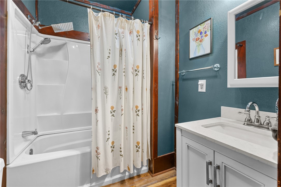 704 Cherry Street Pendleton, SC 29670 - Photo 19 of 28 A well-appointed bathroom features a combined shower and tub, complemented by a modern vanity and mirror.