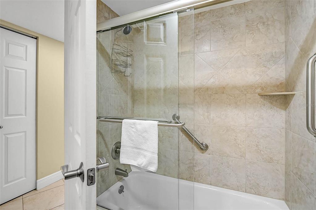 6518 Midnight Pass Road, Unit 407 Sarasota, FL 34242 - Photo 16 of 48 a bathroom with a shower and a bathtub