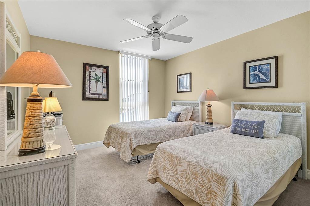 6518 Midnight Pass Road, Unit 407 Sarasota, FL 34242 - Photo 17 of 48 a bedroom with two beds and painting on the wall