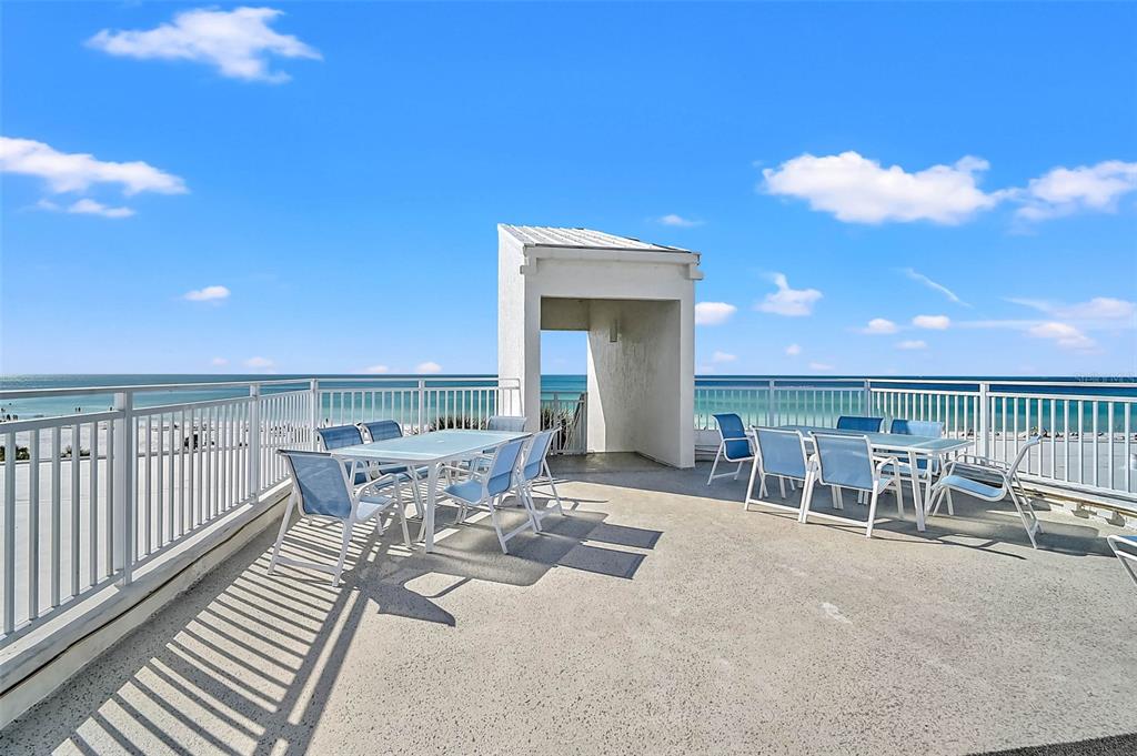 6518 Midnight Pass Road, Unit 407 Sarasota, FL 34242 - Photo 34 of 48 a view of a patio with a table and chairs