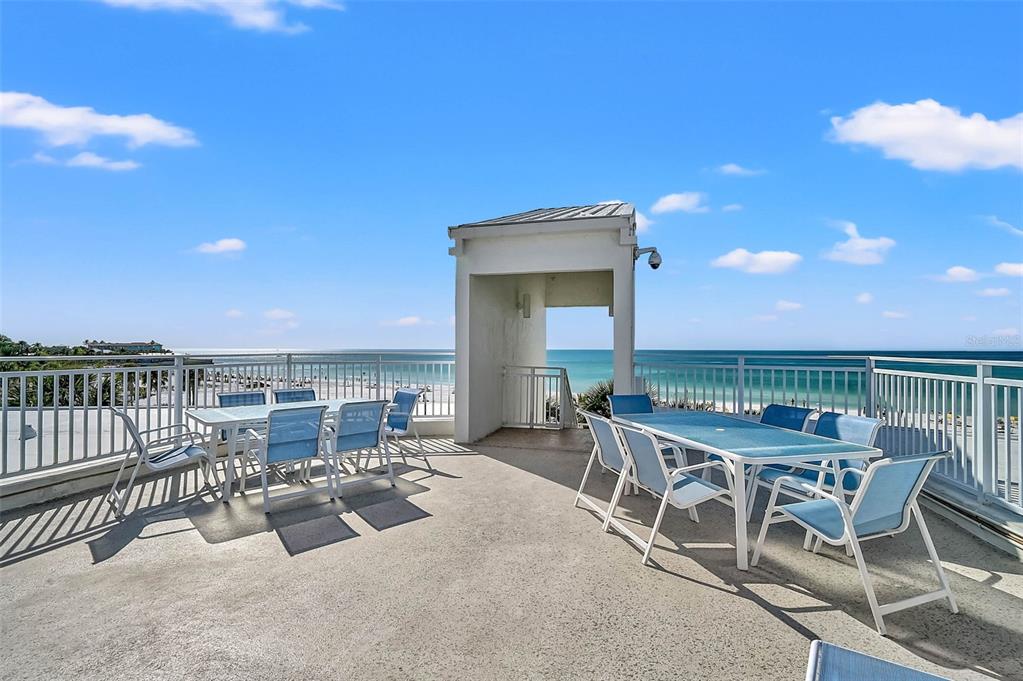 6518 Midnight Pass Road, Unit 407 Sarasota, FL 34242 - Photo 35 of 48 a view of a patio with swimming pool and sitting area