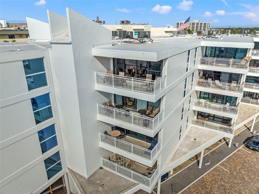 6518 Midnight Pass Road, Unit 407 Sarasota, FL 34242 - Photo 36 of 48 a view of a building with a balcony
