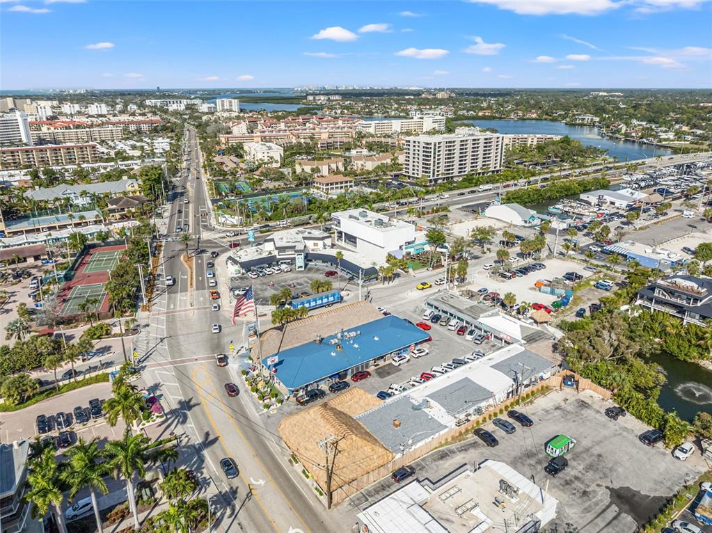 6518 Midnight Pass Road, Unit 407 Sarasota, FL 34242 - Photo 48 of 48 an aerial view of residential building with outdoor space and lake view