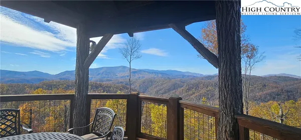 a living room with patio furniture and a fireplace