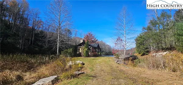 a view of a house with a yard covered with snow in the background