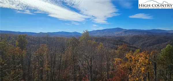 a view of mountain with sunset in background