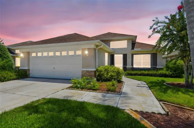 a front view of a house with a yard and garage