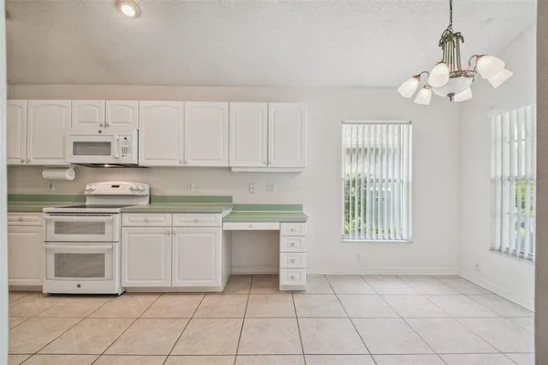a kitchen with a refrigerator and a sink