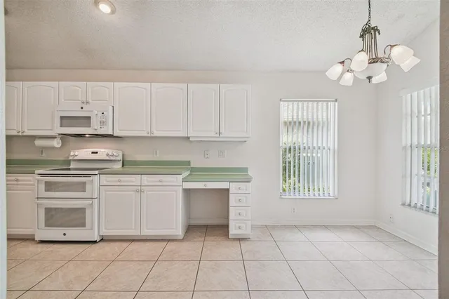 a kitchen with a refrigerator and a sink