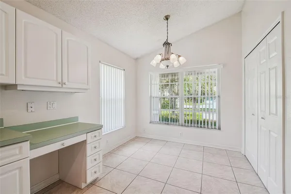 a kitchen with white cabinets appliances and sink