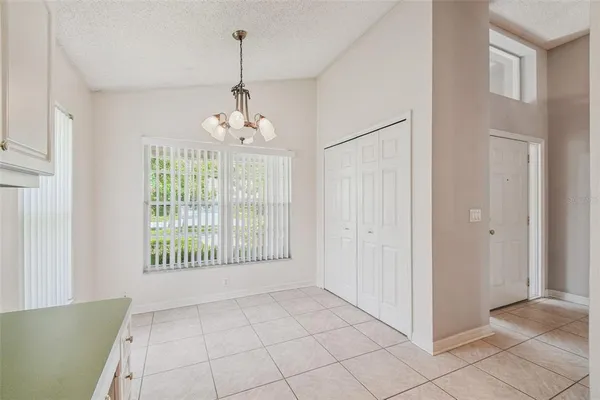 a kitchen with a sink dishwasher and white cabinets with wooden floor