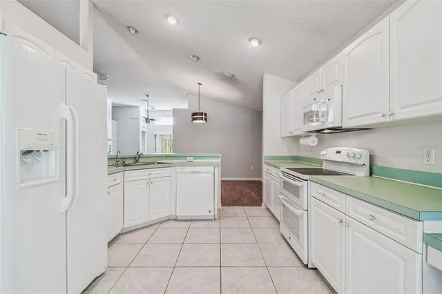 a kitchen with granite countertop a sink and cabinets