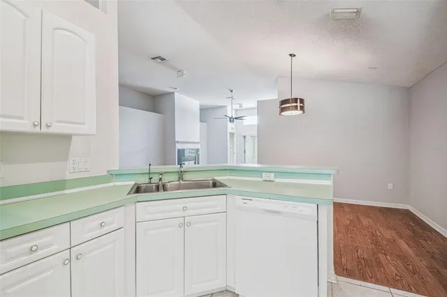 a view of a kitchen with a refrigerator and window